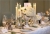 Mercury-silver-candle-sticks-around-stunning-silver-footed-vases-of-hydrangeas-and-roses.jpg